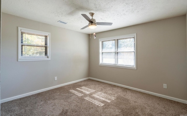 unfurnished room featuring a textured ceiling, carpet, and ceiling fan