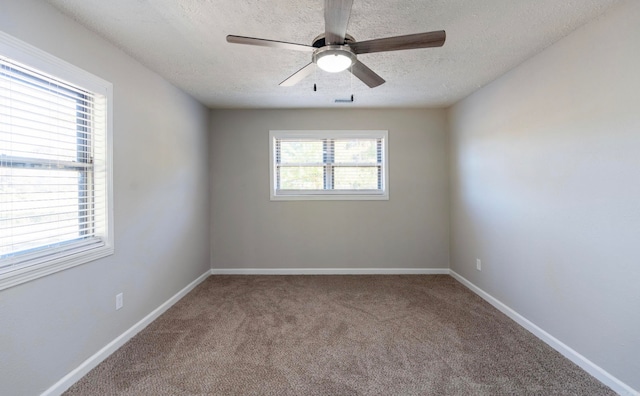 carpeted empty room featuring a textured ceiling and ceiling fan