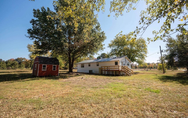 view of yard featuring a storage shed and a deck