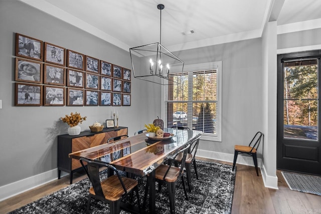 dining area with a notable chandelier and hardwood / wood-style flooring