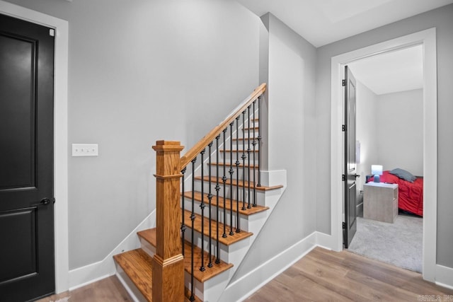 stairs featuring hardwood / wood-style floors