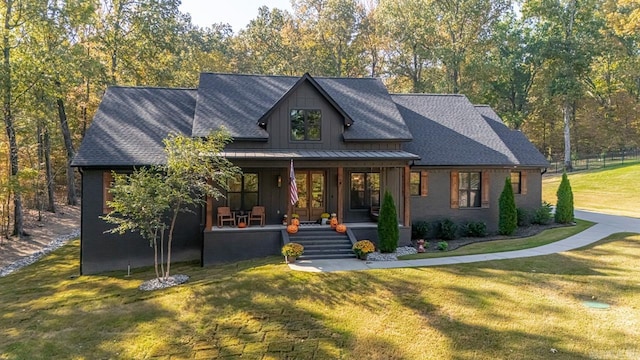 modern inspired farmhouse with a front yard and a porch