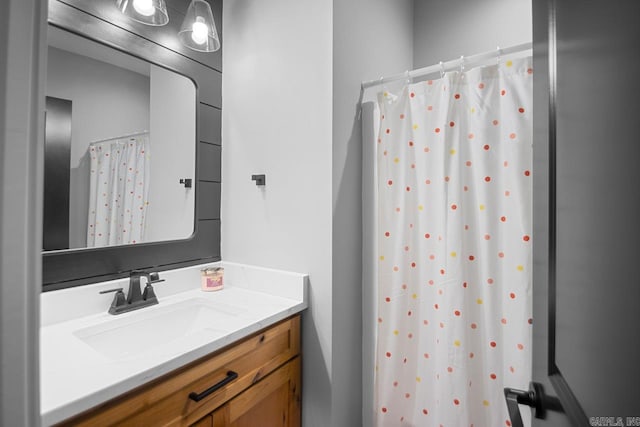 bathroom featuring vanity and curtained shower