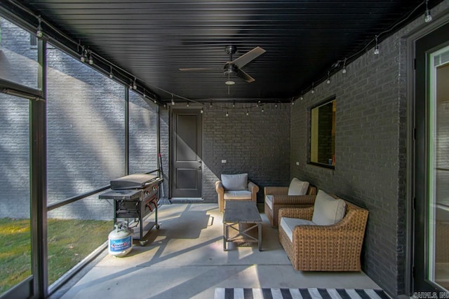 sunroom / solarium featuring ceiling fan