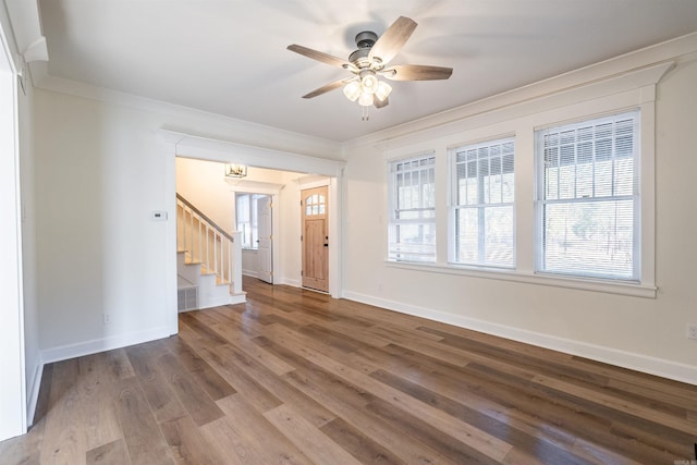 empty room featuring crown molding, wood-type flooring, and ceiling fan