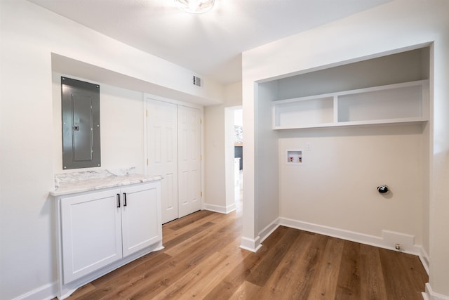 washroom featuring hardwood / wood-style floors, electric panel, and washer hookup