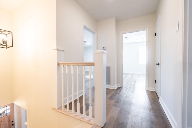 hallway with hardwood / wood-style flooring