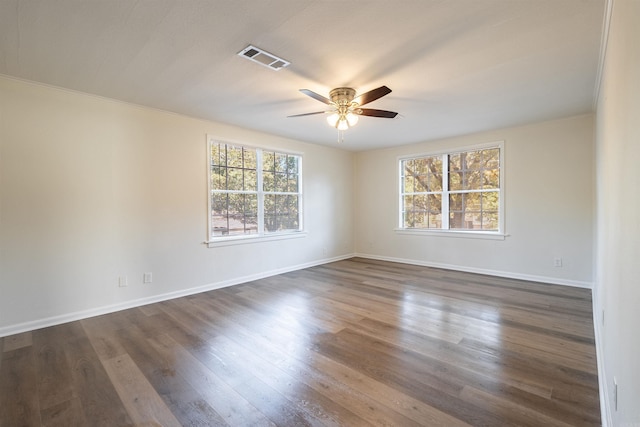 unfurnished room featuring ornamental molding, ceiling fan, and dark hardwood / wood-style flooring