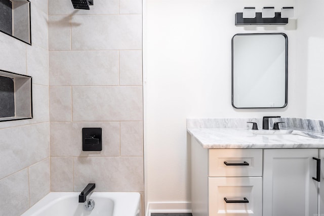 bathroom featuring vanity and tiled shower / bath combo