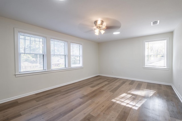 unfurnished room featuring ceiling fan and hardwood / wood-style flooring