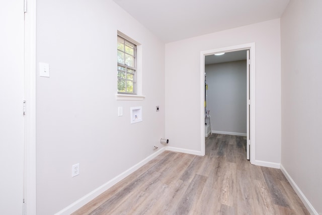 clothes washing area featuring electric dryer hookup, washer hookup, and light wood-type flooring