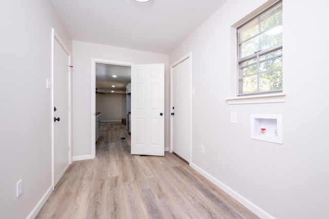 washroom with washer hookup and light hardwood / wood-style floors