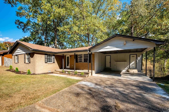 ranch-style house featuring a front yard and a carport