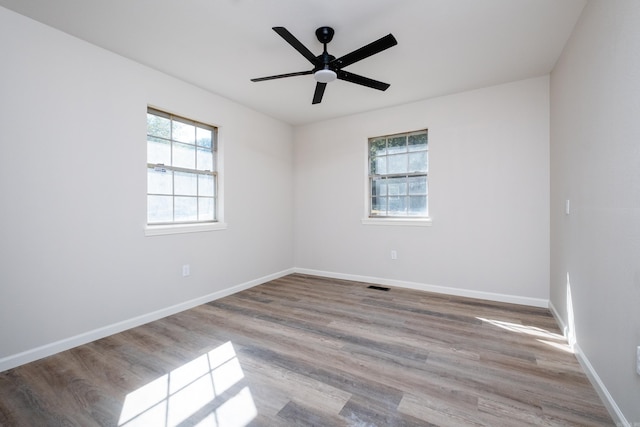 empty room with light hardwood / wood-style flooring and ceiling fan