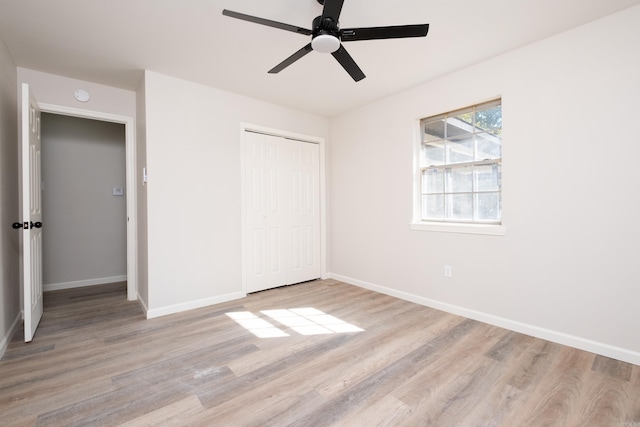 unfurnished bedroom featuring a closet, light wood-type flooring, and ceiling fan