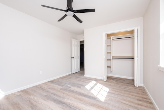 unfurnished bedroom with light hardwood / wood-style flooring, a closet, and ceiling fan