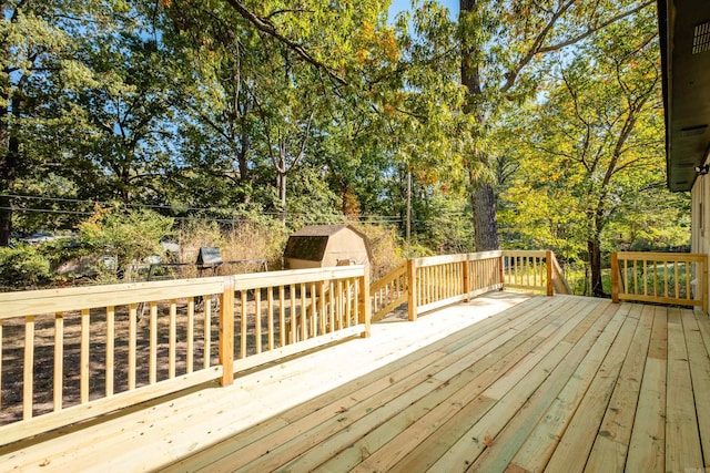 wooden terrace featuring a shed