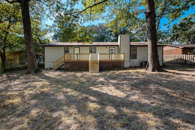 rear view of property with a wooden deck