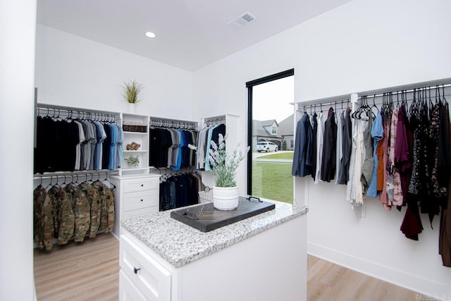 spacious closet with light hardwood / wood-style flooring