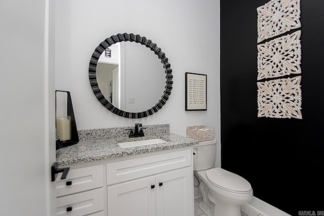 bathroom featuring vanity, toilet, and tile patterned floors