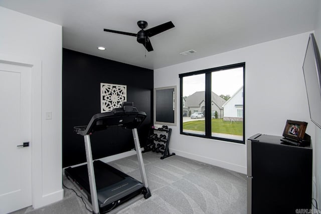 workout room with light colored carpet and ceiling fan