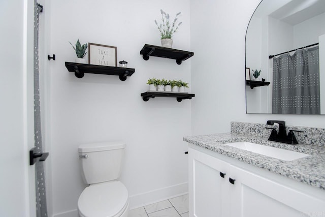 bathroom with vanity, toilet, and tile patterned floors