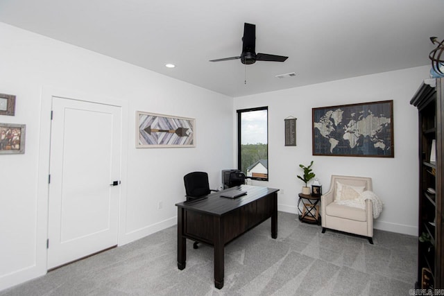 carpeted home office featuring ceiling fan