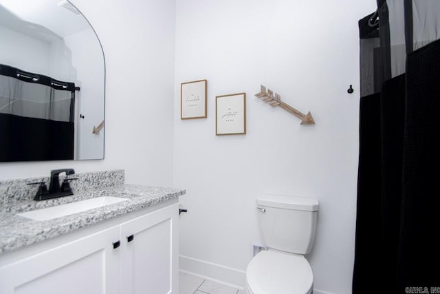 bathroom with toilet, a shower with curtain, vanity, and tile patterned flooring