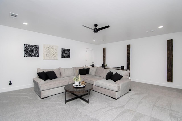 carpeted living room with ceiling fan