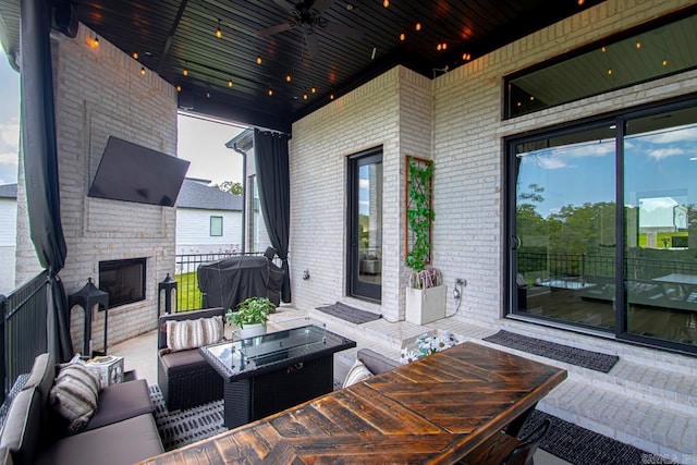 view of patio with an outdoor living space, grilling area, and ceiling fan