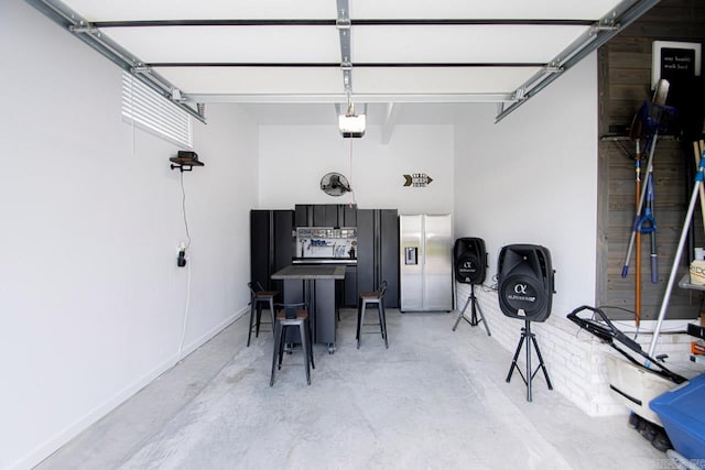 garage with stainless steel fridge with ice dispenser