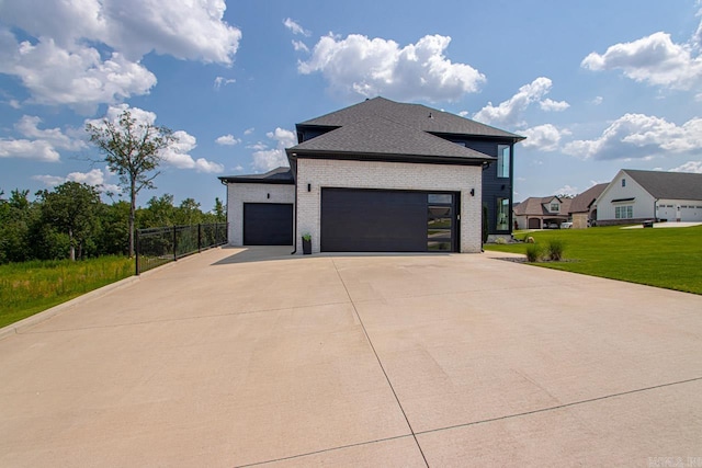 view of side of property featuring a yard and a garage