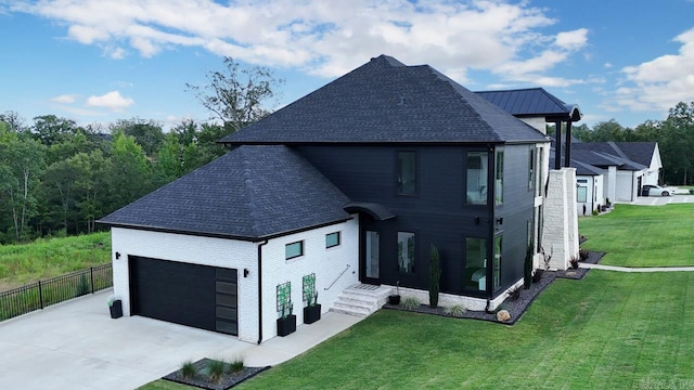 exterior space with a garage and a lawn