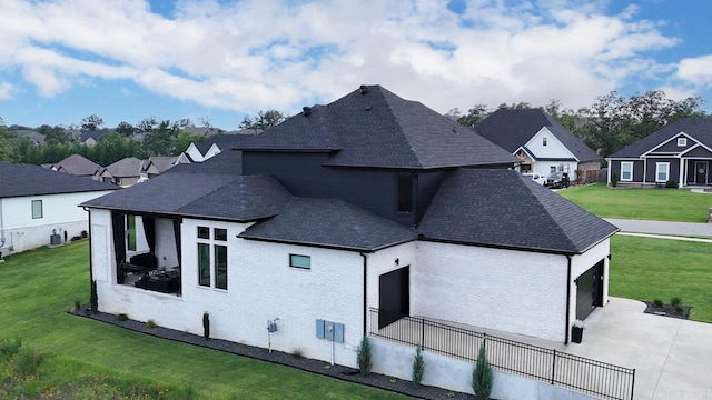 rear view of property featuring a yard and a garage