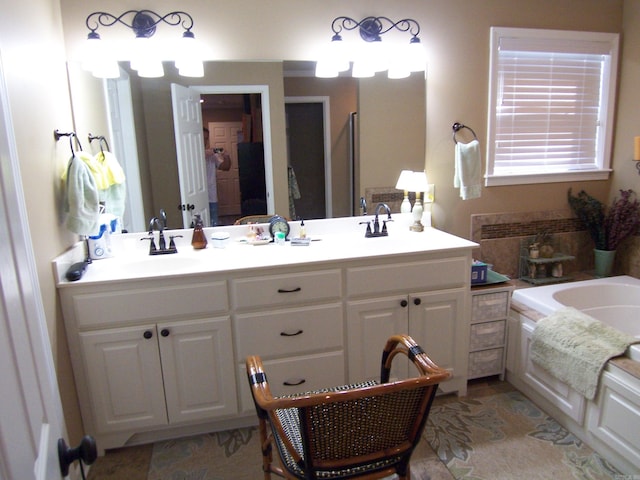 bathroom featuring vanity and a washtub