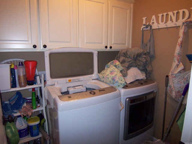 laundry area featuring cabinets and washing machine and clothes dryer