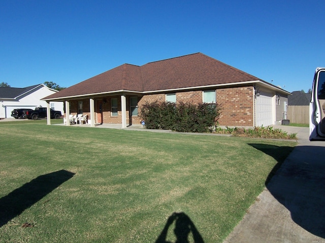 exterior space featuring a garage and a lawn