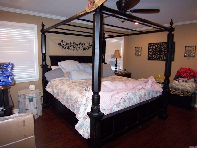 bedroom featuring ornamental molding, ceiling fan, multiple windows, and dark hardwood / wood-style flooring