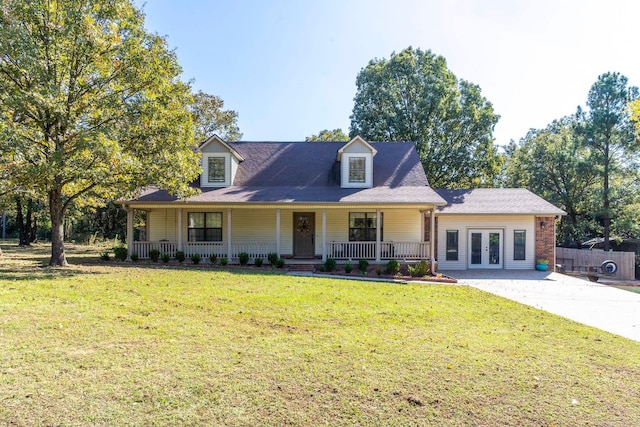 view of front facade featuring french doors, a front lawn, and covered porch