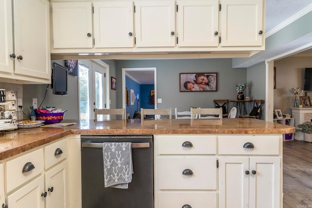 kitchen with kitchen peninsula, hardwood / wood-style floors, white cabinets, stainless steel dishwasher, and crown molding