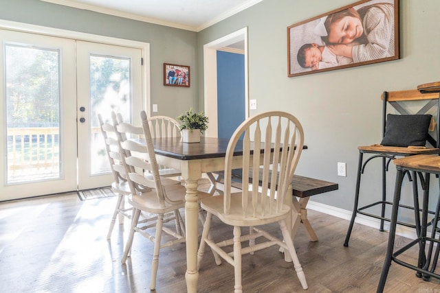 dining area with french doors, ornamental molding, and hardwood / wood-style floors