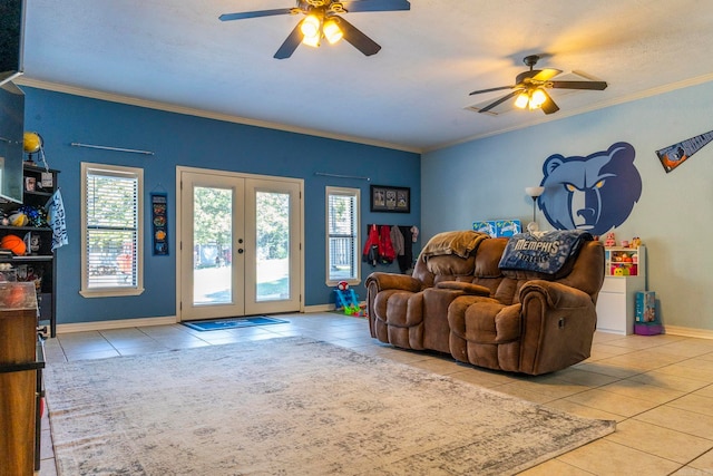 tiled living room featuring french doors, ceiling fan, ornamental molding, and a textured ceiling