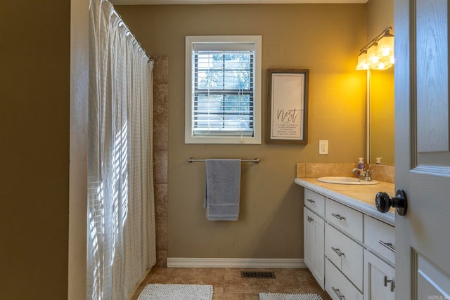 bathroom with vanity and tile patterned flooring