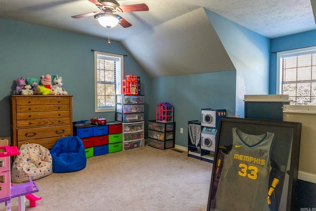 playroom with lofted ceiling, carpet floors, and a healthy amount of sunlight