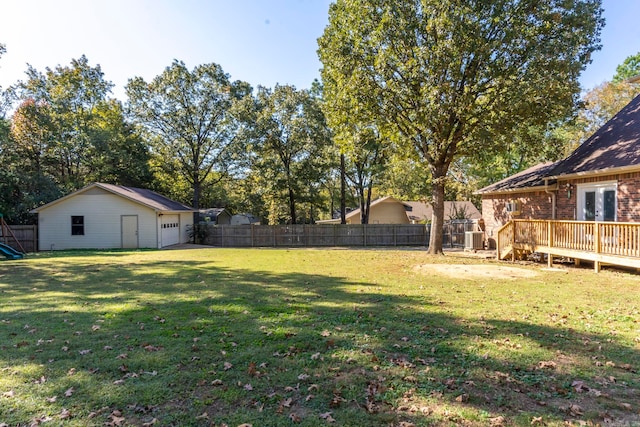 view of yard with a wooden deck and an outbuilding