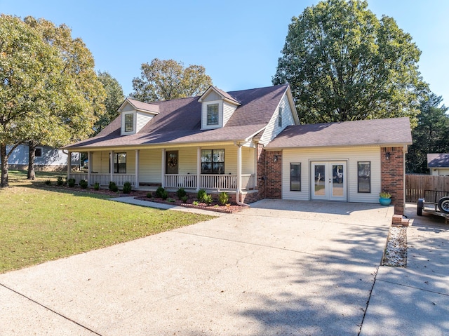 view of front of house with french doors, covered porch, and a front yard