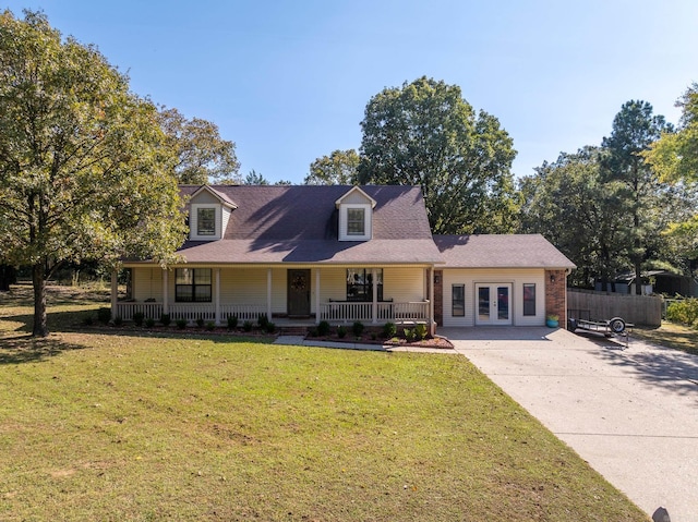 cape cod house featuring a front yard and covered porch