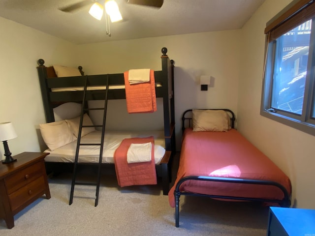 bedroom with ceiling fan and light colored carpet