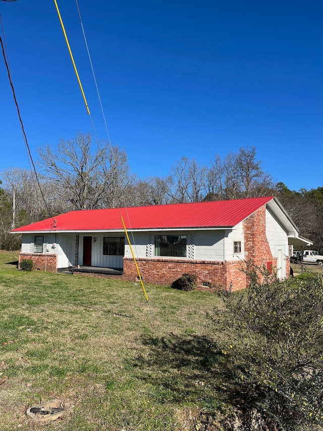 back of property with a lawn