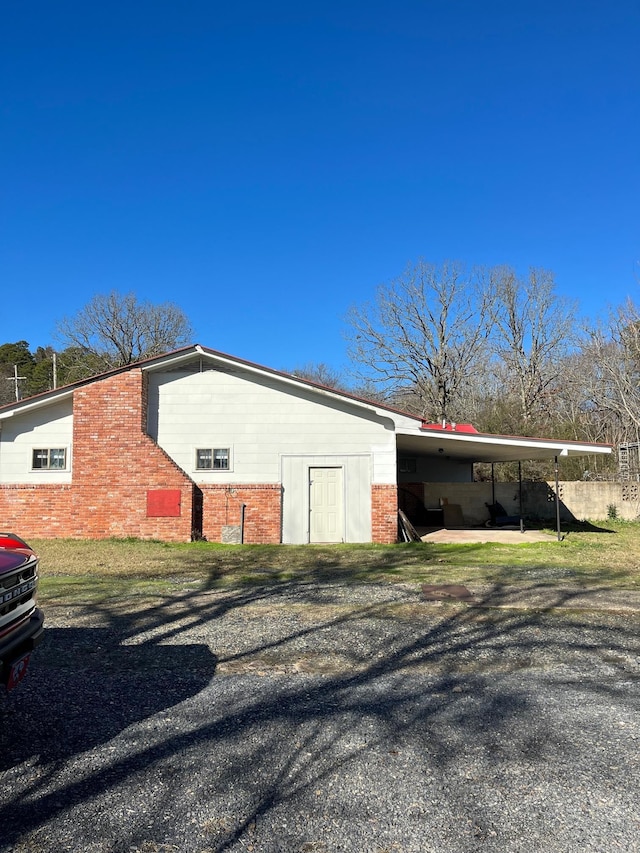 view of side of home with a carport